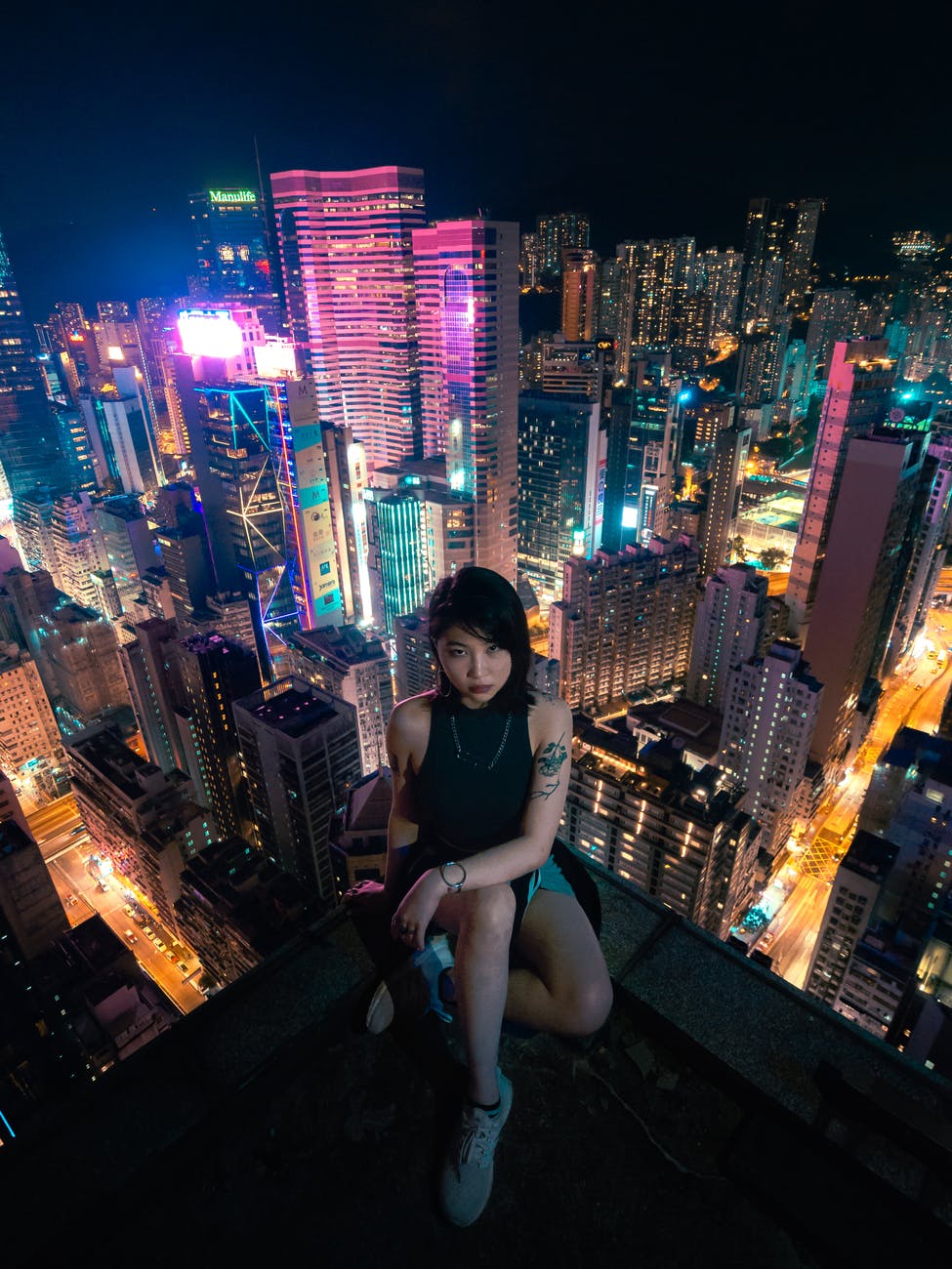 photo of woman sitting on rooftop